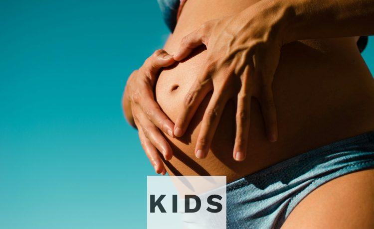 closeup photography of pregnant woman wearing blue panty