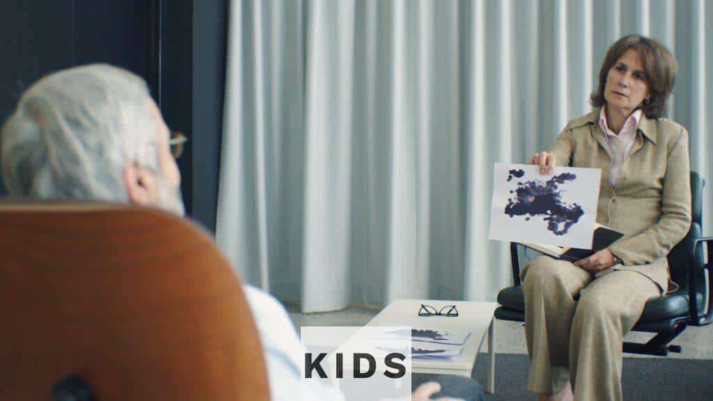 A therapist and patient in a psychotherapy session, discussing inkblot test results.