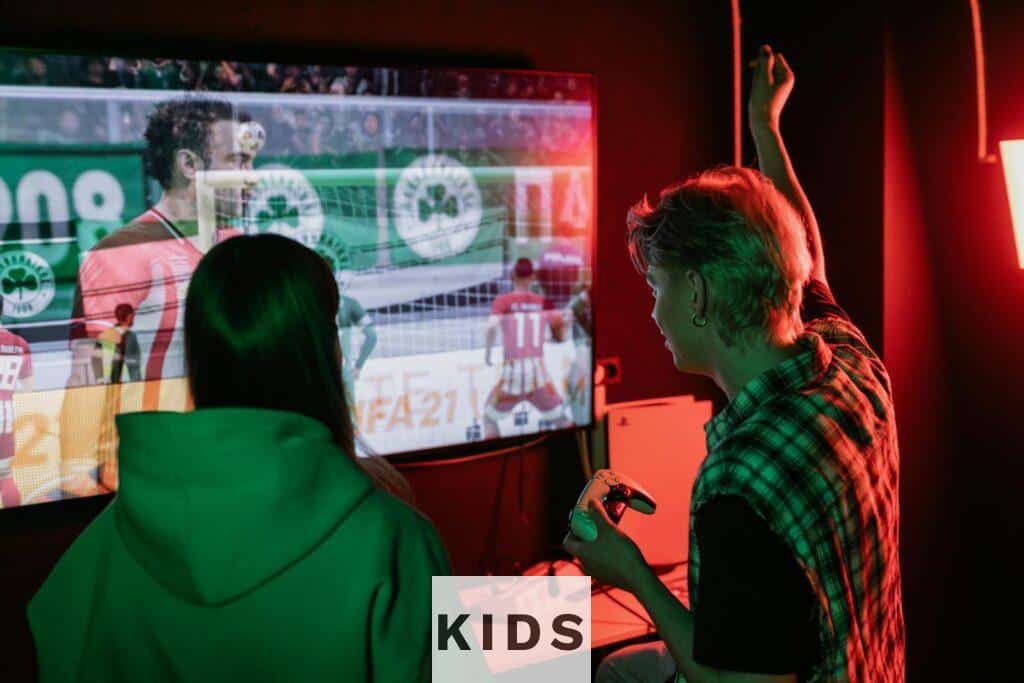 Two friends enjoying an exhilarating video game session indoors, captured with vibrant lighting.