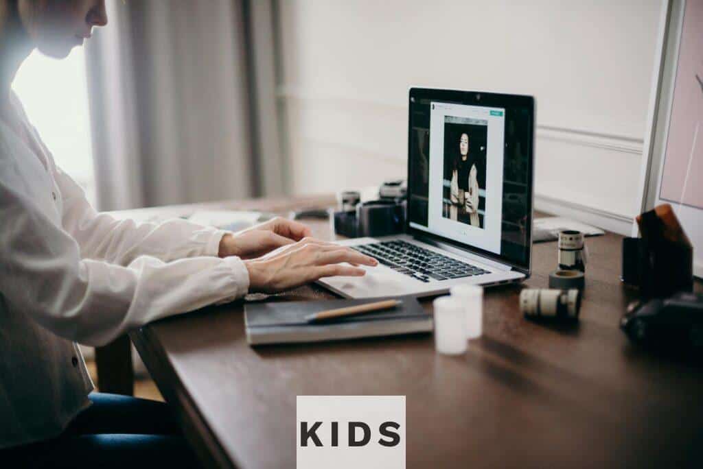 A freelancer working on a laptop in a cozy home office, focusing on creative design tasks.