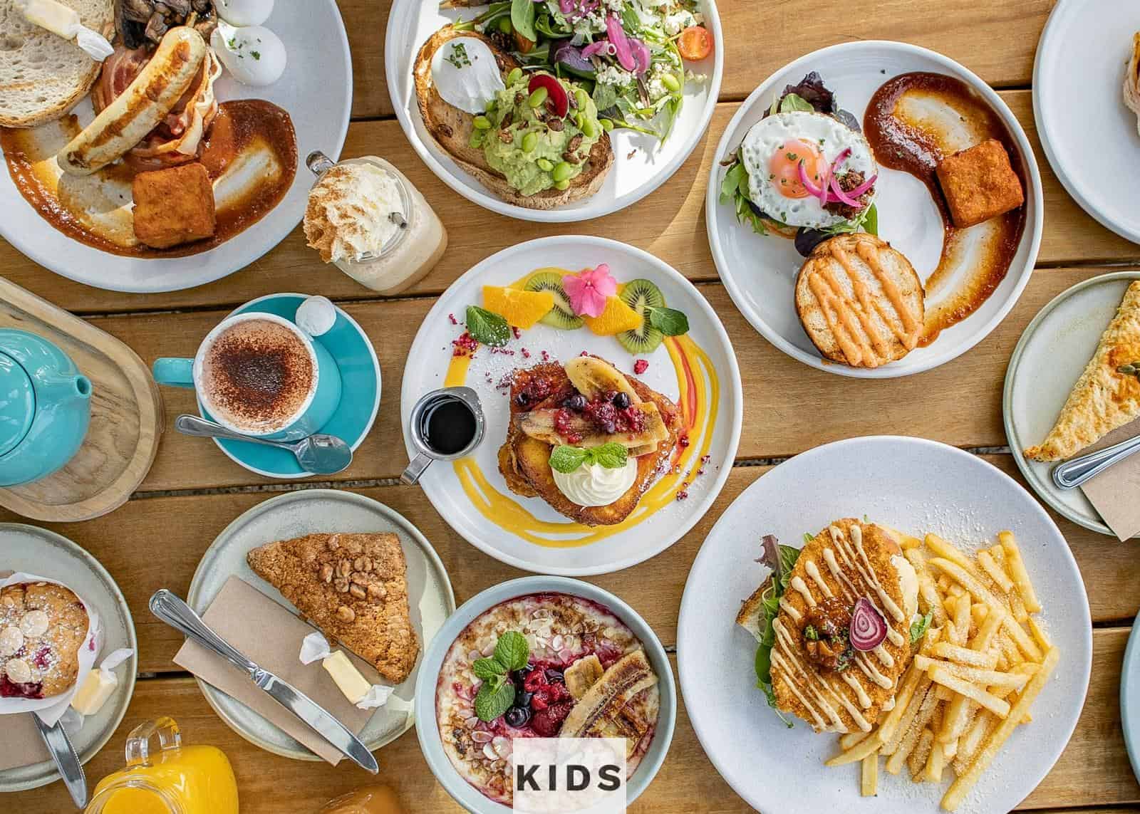 a table topped with lots of plates of food